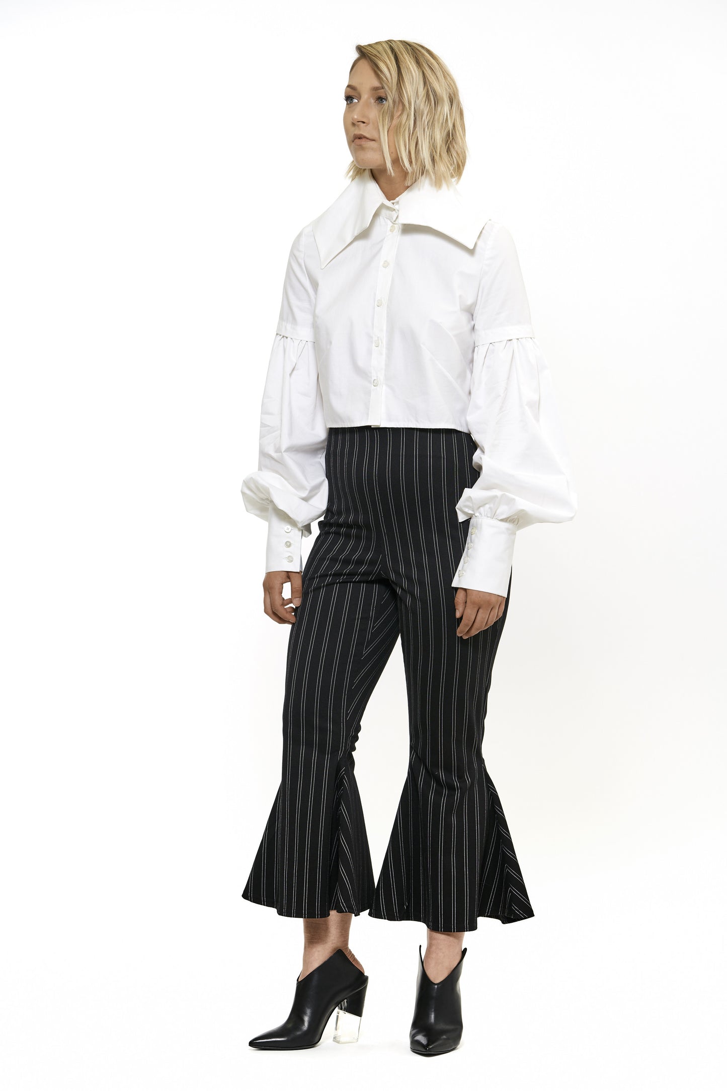 Semi-fitted cotton shirt dress. Large billowing sleeves with a tall structured cuff and collar. Made with a luxurious belevdere cotton, a lightweight cotton sateen features a sophisticated sheen. Model wear size 4.