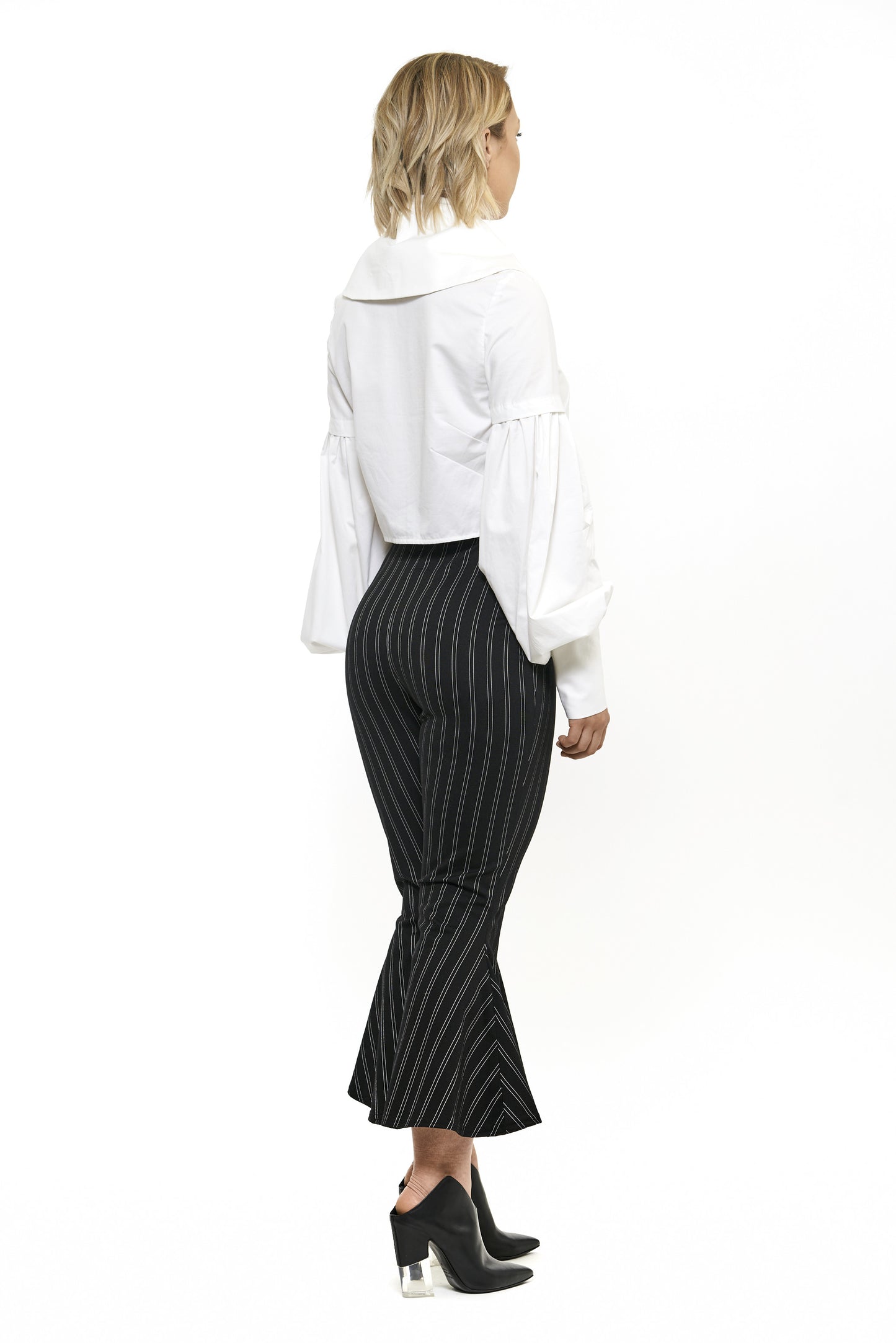 Semi-fitted cotton shirt dress. Large billowing sleeves with a tall structured cuff and collar. Made with a luxurious belevdere cotton, a lightweight cotton sateen features a sophisticated sheen. Model wear size 4.