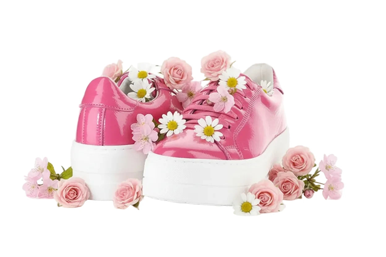 Pink sneakers with white soles on a white background